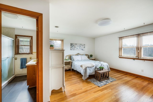 bedroom with wood finished floors and baseboards