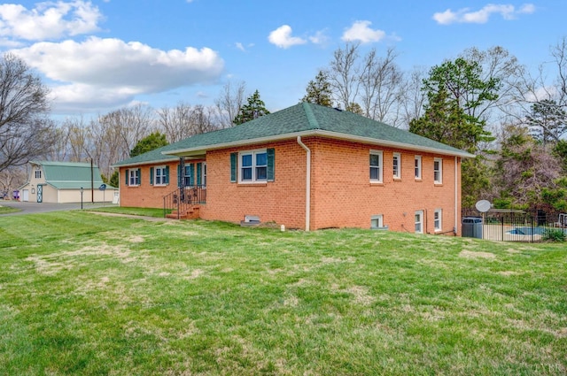 view of side of property with brick siding, a shingled roof, and central AC