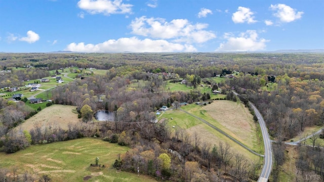 aerial overview of property's location featuring a forest and rural landscape