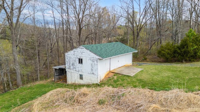 view of outbuilding with an outdoor structure and a view of trees