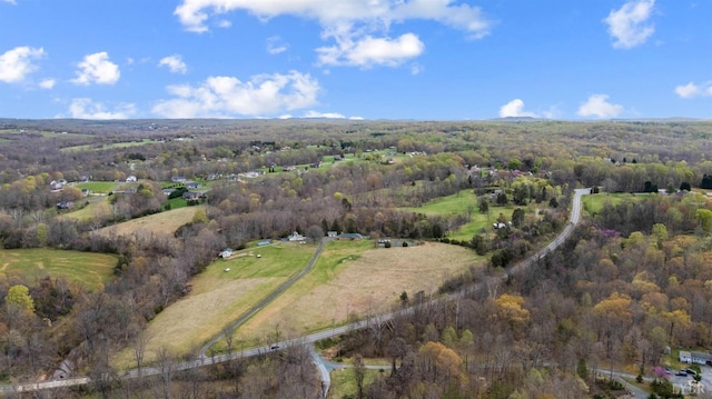 aerial view of property's location featuring a heavily wooded area