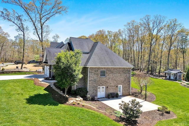 1062 Ivy Creek Dr, Forest, VA 24551 - view of property exterior featuring a patio area, a lawn, brick siding, and an outdoor structure