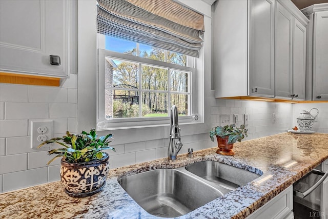 1062 Ivy Creek Dr, Forest, VA 24551 - kitchen with a sink, decorative backsplash, and light stone counters