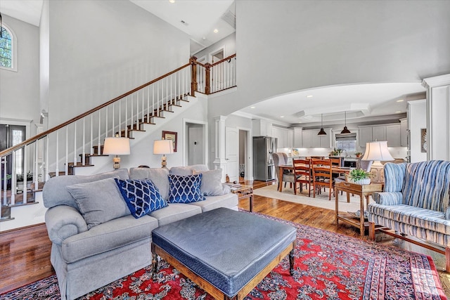 1062 Ivy Creek Dr, Forest, VA 24551 - living room featuring a towering ceiling, wood finished floors, arched walkways, stairs, and recessed lighting