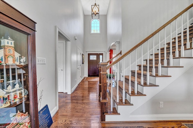 1062 Ivy Creek Dr, Forest, VA 24551 - foyer entrance featuring a high ceiling, arched walkways, wood finished floors, stairway, and baseboards