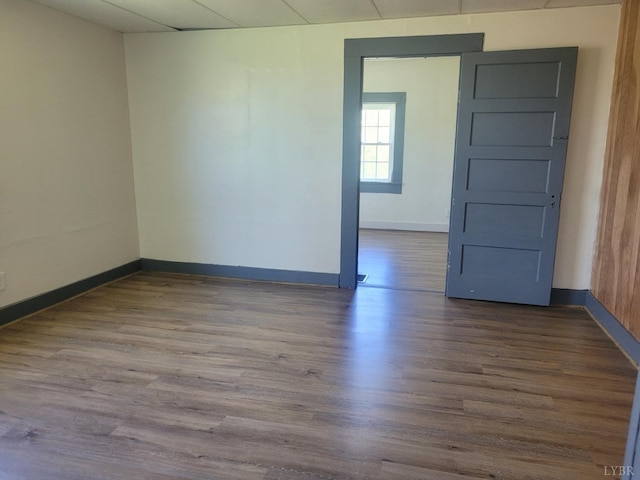spare room featuring wood finished floors and baseboards