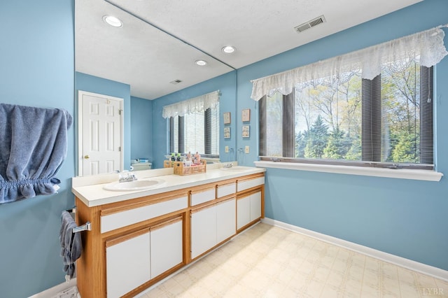 502 Fairwinds Ct, Forest, VA 24551 - bathroom featuring double vanity, baseboards, recessed lighting, tile patterned floors, and toilet
