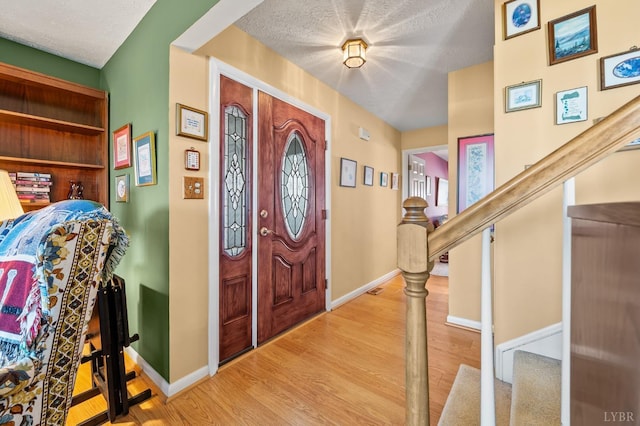 502 Fairwinds Ct, Forest, VA 24551 - entrance foyer featuring wood finished floors, baseboards, stairs, and a textured ceiling