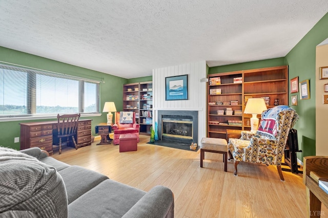 502 Fairwinds Ct, Forest, VA 24551 - living area with a fireplace with flush hearth, wood finished floors, and a textured ceiling