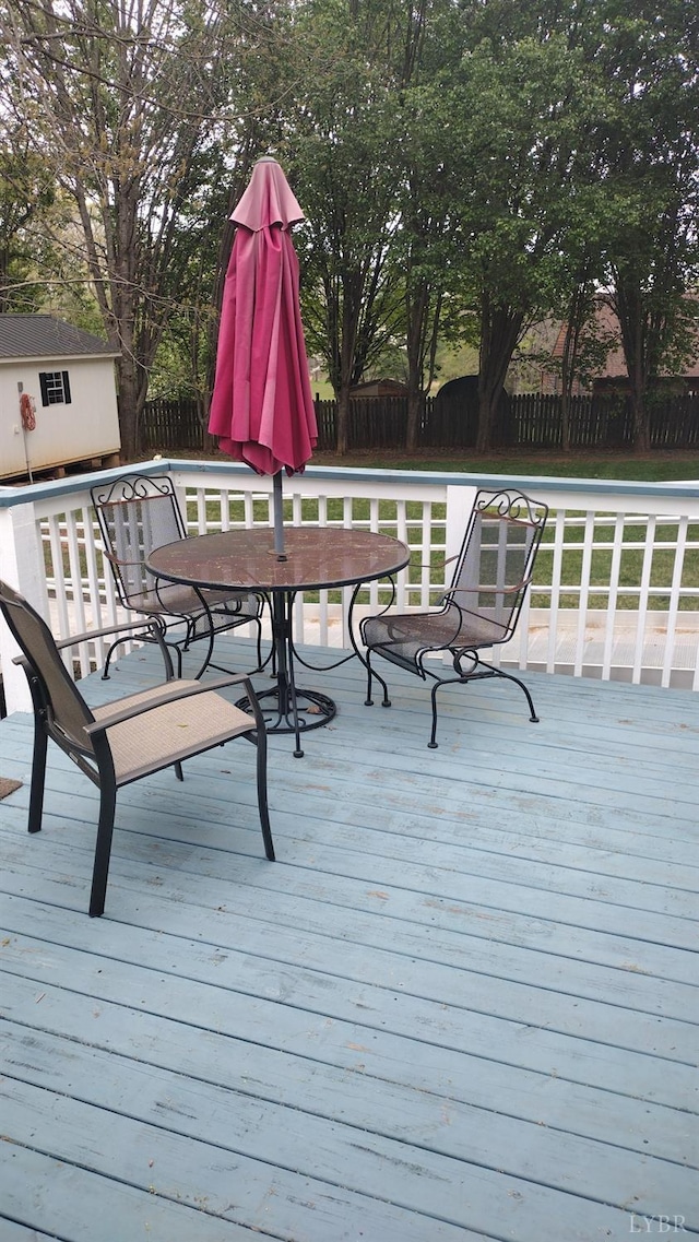 618 Prospect Rd, Hurt, VA 24563 - deck with a fenced backyard, a storage shed, outdoor dining space, and an outbuilding