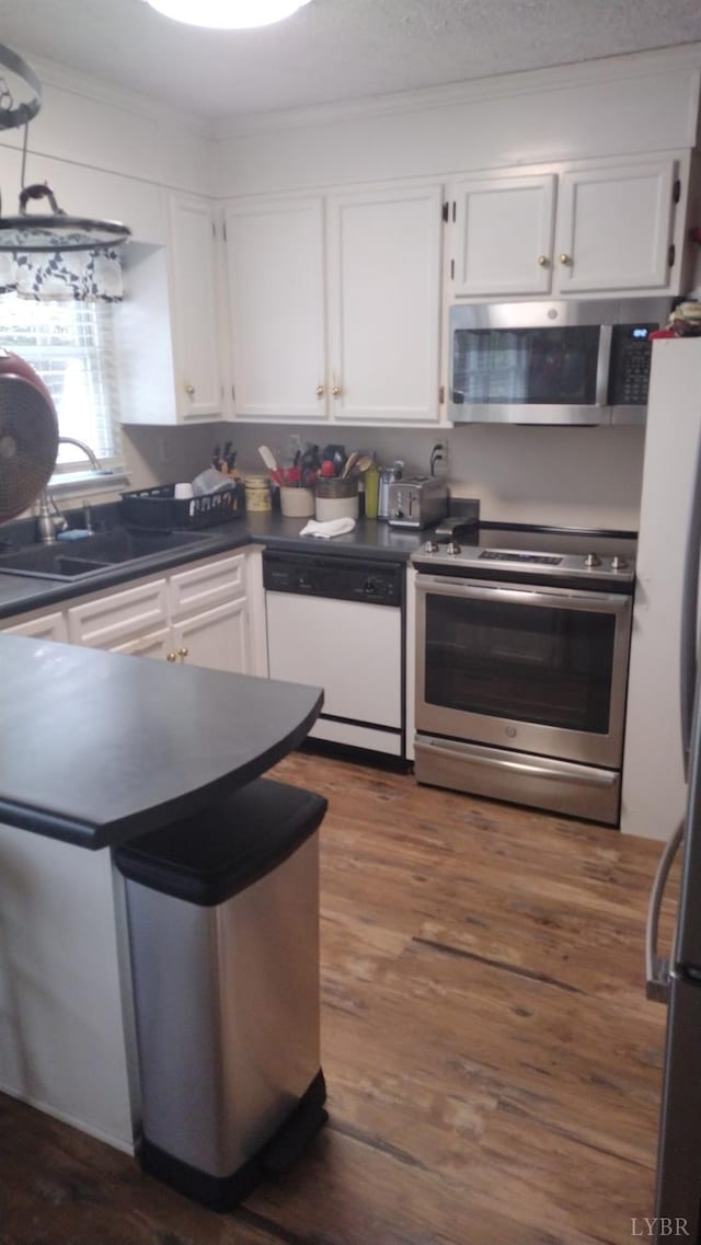 618 Prospect Rd, Hurt, VA 24563 - kitchen featuring dark wood-style flooring, a sink, white cabinetry, dark countertops, and stainless steel appliances