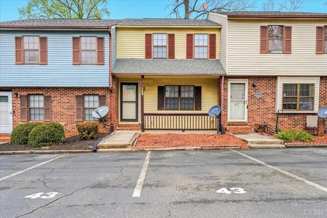 43 Nags Head Ct, Lynchburg, VA 24502 - view of property with uncovered parking, brick siding, and a porch