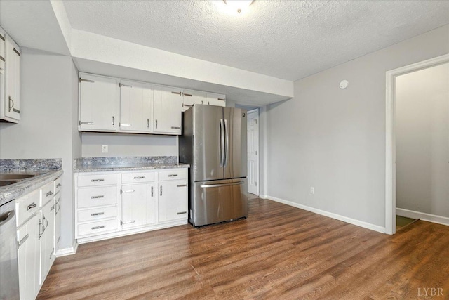 43 Nags Head Ct, Lynchburg, VA 24502 - kitchen featuring stainless steel appliances, white cabinetry, wood finished floors, a textured ceiling, and baseboards