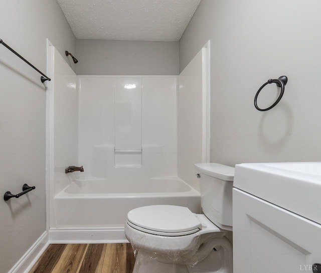 108 Trapper Ln, Vinton, VA 24179 - full bath with toilet, wood finished floors, a textured ceiling,  shower combination, and baseboards