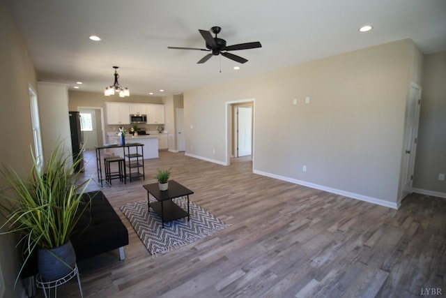 625 S St, Bedford, VA 24523 - living room with a chandelier, a ceiling fan, baseboards, light wood finished floors, and recessed lighting