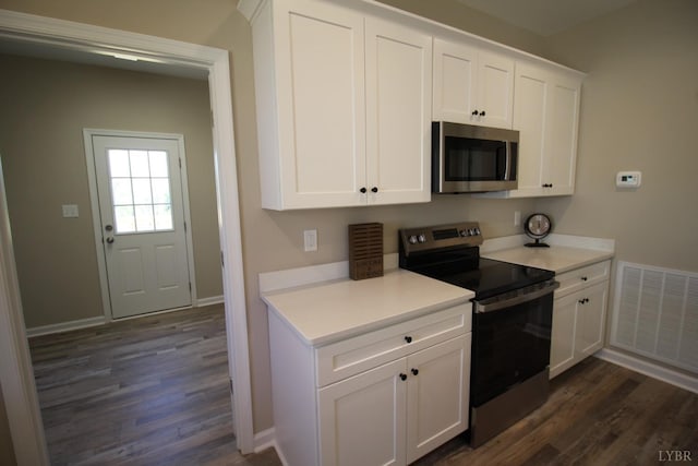 625 S St, Bedford, VA 24523 - kitchen featuring appliances with stainless steel finishes, dark wood-type flooring, and white cabinetry