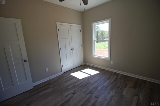 625 S St, Bedford, VA 24523 - unfurnished bedroom featuring dark wood finished floors, baseboards, a closet, and a ceiling fan