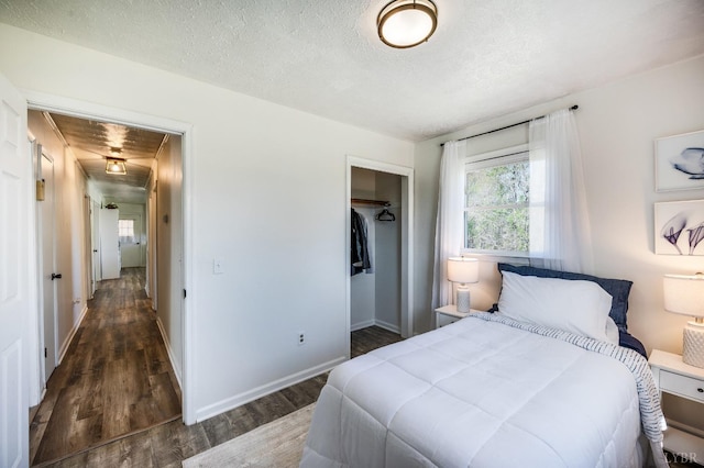 2477 Mountain Rd, Gretna, VA 24557 - bedroom with a closet, a textured ceiling, baseboards, and wood finished floors