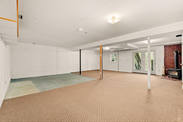 303 Somerset Pl, Rustburg, VA 24588 - below grade area featuring a wood stove and carpet