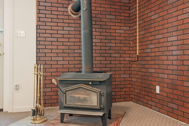 303 Somerset Pl, Rustburg, VA 24588 - detailed view of brick wall, a wood stove, and carpet