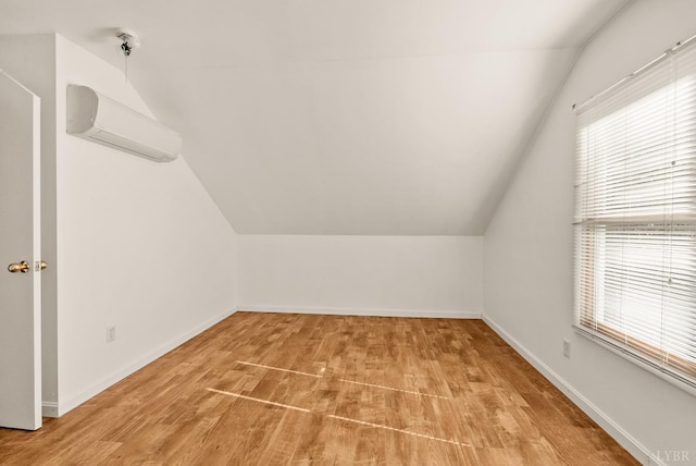 303 Somerset Pl, Rustburg, VA 24588 - additional living space with lofted ceiling, a wall mounted AC, plenty of natural light, and wood finished floors