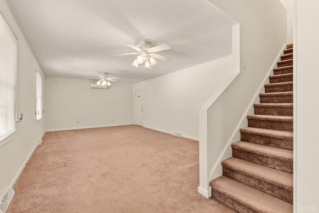 303 Somerset Pl, Rustburg, VA 24588 - unfurnished living room with stairway, ceiling fan, light carpet, and a wall mounted air conditioner