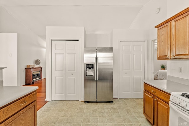 303 Somerset Pl, Rustburg, VA 24588 - kitchen with stainless steel refrigerator with ice dispenser, white range oven, light countertops, and brown cabinetry