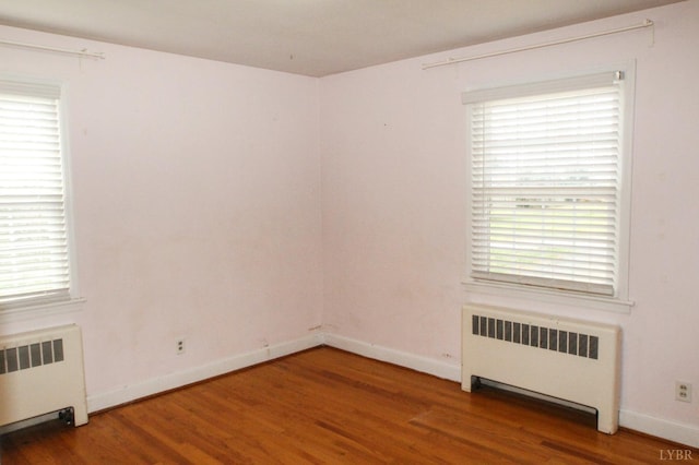 1428 Club Dr, Lynchburg, VA 24503 - spare room featuring radiator, wood finished floors, and healthy amount of natural light