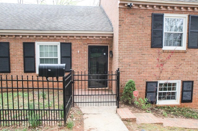 1428 Club Dr, Lynchburg, VA 24503 - view of exterior entry with fence, a gate, brick siding, and a shingled roof