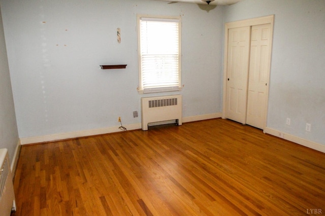 1428 Club Dr, Lynchburg, VA 24503 - unfurnished bedroom featuring radiator, wood finished floors, and baseboards