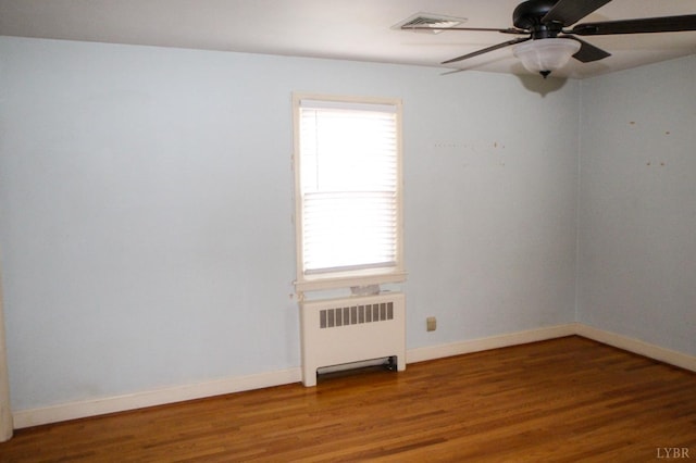 1428 Club Dr, Lynchburg, VA 24503 - spare room featuring radiator, a ceiling fan, wood finished floors, and baseboards