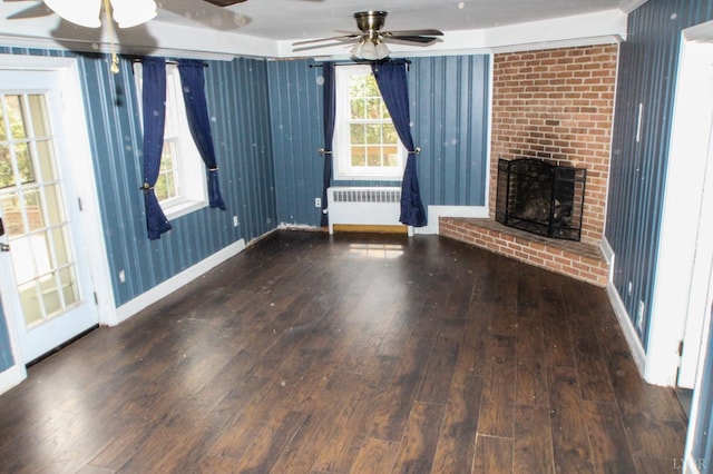 1428 Club Dr, Lynchburg, VA 24503 - unfurnished living room with radiator heating unit, wood-type flooring, ceiling fan, baseboards, and a brick fireplace