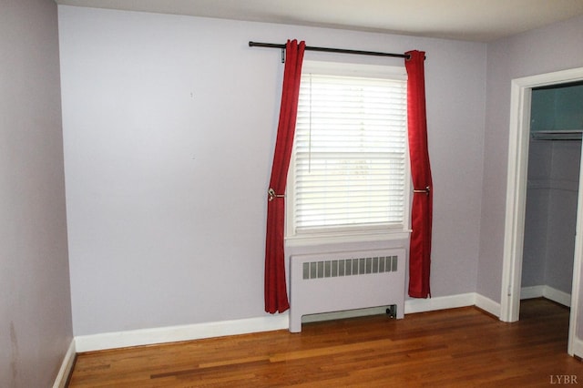 1428 Club Dr, Lynchburg, VA 24503 - unfurnished bedroom with radiator, wood finished floors, baseboards, and a closet