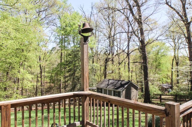 1428 Club Dr, Lynchburg, VA 24503 - deck featuring an outdoor structure, a storage unit, a lawn, and a view of trees