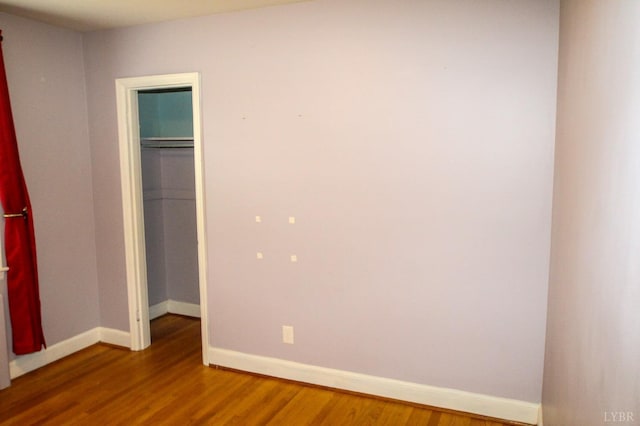 1428 Club Dr, Lynchburg, VA 24503 - unfurnished bedroom with wood finished floors, baseboards, a closet, and a spacious closet
