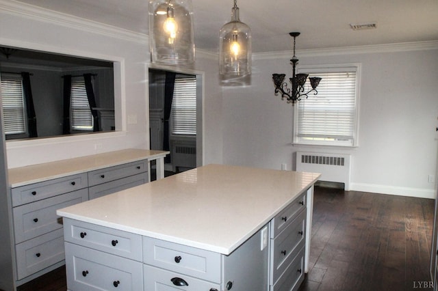 1428 Club Dr, Lynchburg, VA 24503 - kitchen featuring radiator, gray cabinetry, a chandelier, ornamental molding, and dark wood-style flooring