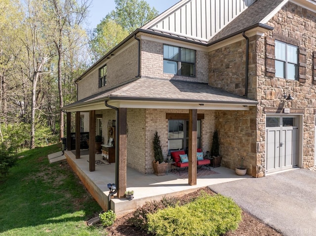 1085 Tori Ct, Forest, VA 24551 - exterior space featuring a shingled roof, stone siding, a lawn, board and batten siding, and a patio