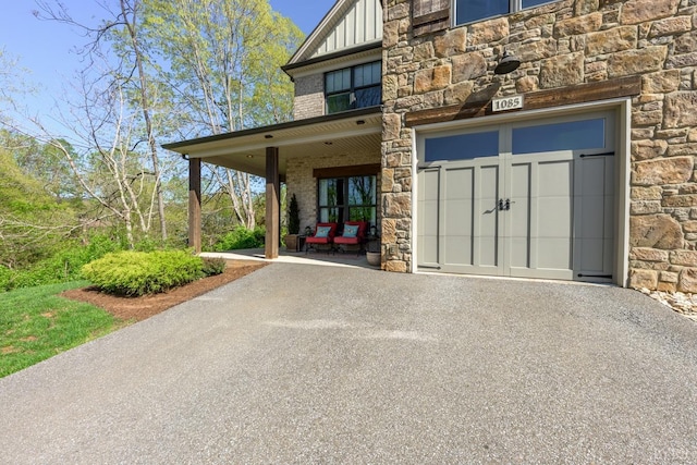 1085 Tori Ct, Forest, VA 24551 - exterior space with board and batten siding, stone siding, a garage, and driveway
