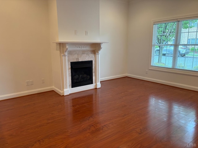 621 Capstone Dr, Lynchburg, VA 24502 - unfurnished living room with baseboards, a tile fireplace, and dark wood-style floors