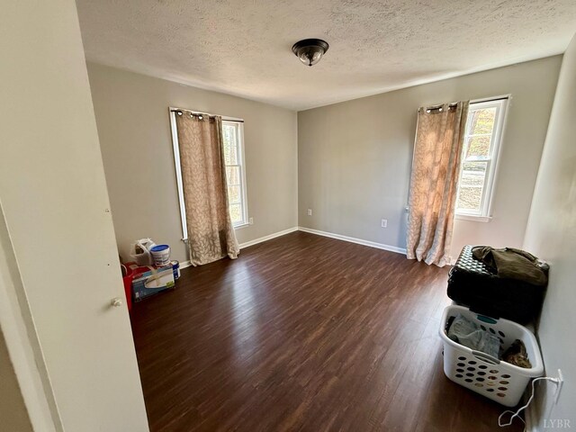 126 Berkley Pl, Madison Heights, VA 24572 - spare room with dark wood-type flooring, a textured ceiling, and baseboards