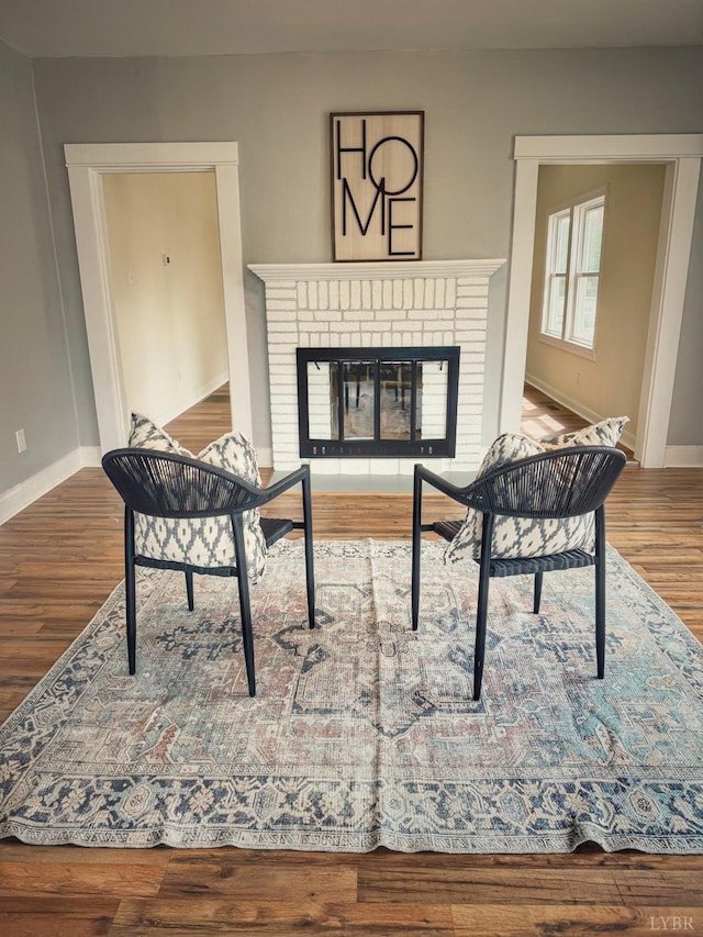 1225 Early St, Lynchburg, VA 24502 - living area with wood finished floors, baseboards, and a brick fireplace