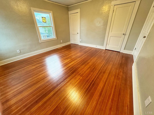 1225 Early St, Lynchburg, VA 24502 - unfurnished bedroom featuring wood finished floors, a textured wall, crown molding, and baseboards