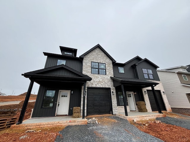 1026 Misty Mountain Rd, Lynchburg, VA 24502 - view of front of home with covered porch, stone siding, board and batten siding, and a garage