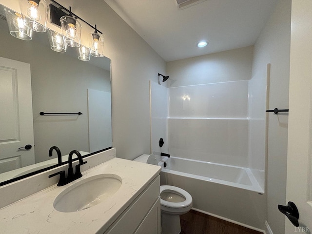 full bathroom featuring vanity, wood finished floors, shower / tub combination, and toilet