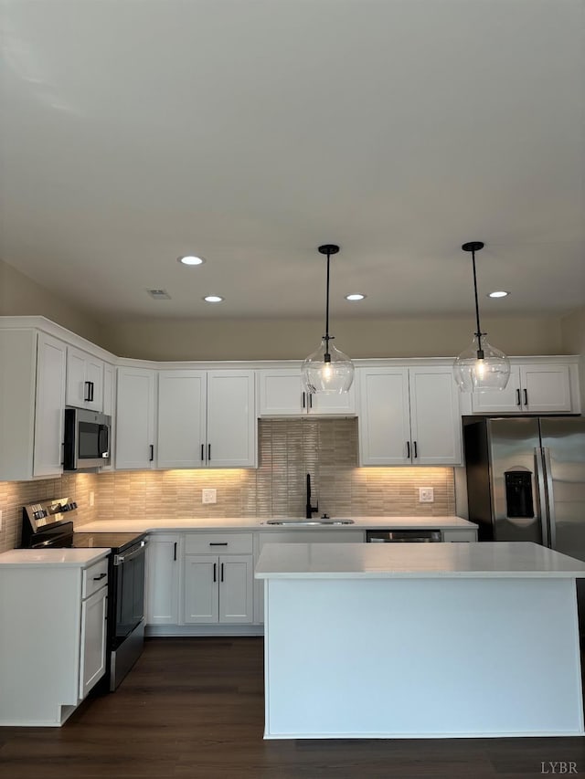kitchen with light countertops, visible vents, a sink, appliances with stainless steel finishes, and white cabinetry
