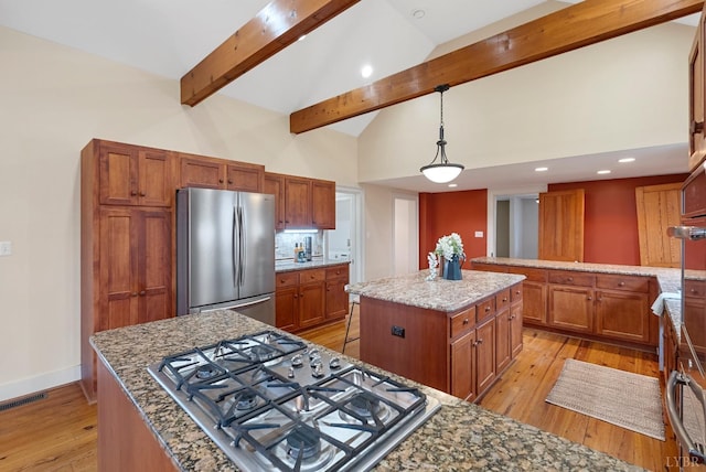 281 Calohan Rd, Rustburg, VA 24588 - kitchen with a center island, light wood-style flooring, appliances with stainless steel finishes, beam ceiling, and visible vents
