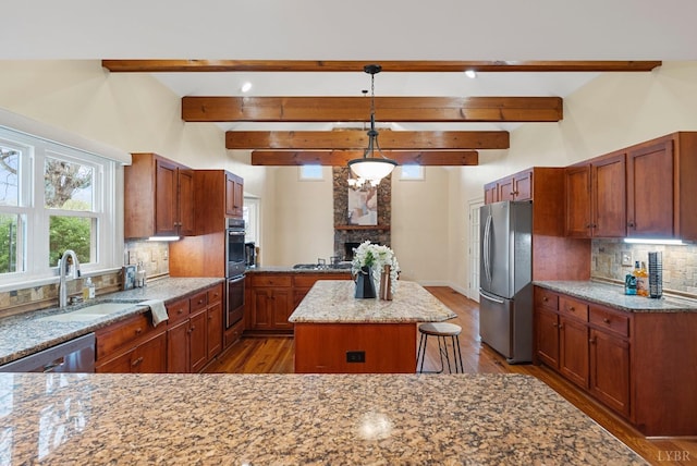 281 Calohan Rd, Rustburg, VA 24588 - kitchen with a center island, a sink, a fireplace, wood finished floors, and stainless steel appliances