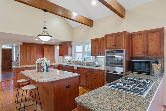 281 Calohan Rd, Rustburg, VA 24588 - kitchen featuring a peninsula, a kitchen island, light stone countertops, beam ceiling, and appliances with stainless steel finishes