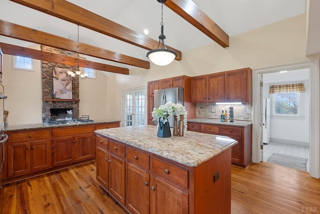 281 Calohan Rd, Rustburg, VA 24588 - kitchen with light wood-type flooring, a chandelier, a center island, appliances with stainless steel finishes, and beam ceiling