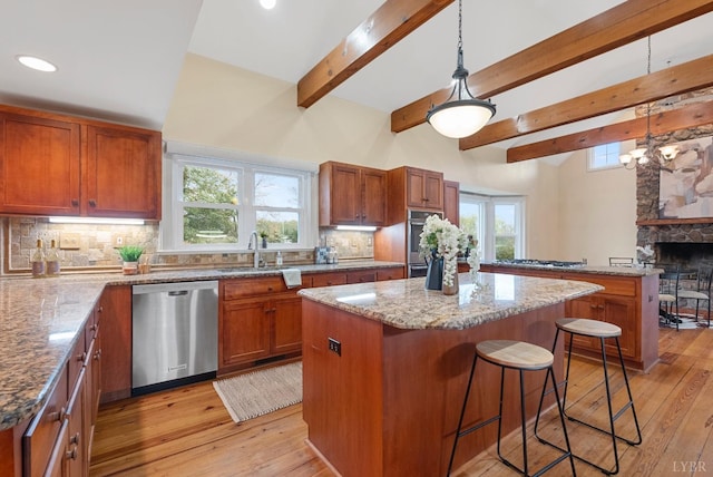 281 Calohan Rd, Rustburg, VA 24588 - kitchen with a breakfast bar, a kitchen island, appliances with stainless steel finishes, light stone counters, and a sink